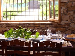 a table with chairs and a table set up in a restaurant at Huerta el Fontanarillo in Montemayor