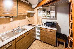 a small kitchen with a sink and a microwave at Apartment on Svobody Avenue 47 in Lviv
