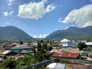 a view of a city with mountains in the background at Victory Hotel in Ruteng
