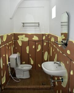 a bathroom with a toilet and a sink at Jorge Transient House in Coron