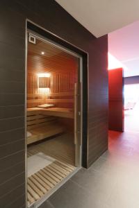 a sauna with a glass door in a room at Royal Antibes - Luxury Hotel, Résidence, Beach & Spa in Antibes