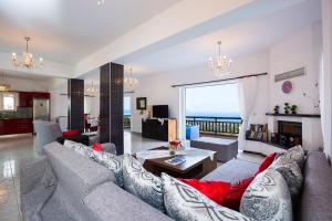 a living room with a couch and a table at Ekaterini Vip Villa in Plaka