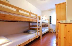 a bedroom with two bunk beds in a room at Casa Lulu' in Predazzo
