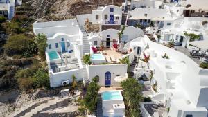 an overhead view of a white house with blue doors at Ifestio Villas Oia in Oia