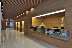 an office lobby with a reception sign on the wall at Kenzi Basma in Casablanca