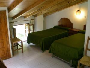 Säng eller sängar i ett rum på Hotel Puerta Romeros