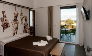 a bedroom with a bed and a balcony with a table at AGRO Sicily in Mascali +99 photos