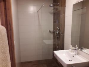 a bathroom with a sink and a shower at Ferienwohnung Eiterer in Kauns