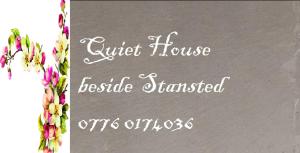 a sign for a guest house with flowers on it at Quiet house beside Stansted Airport in Bishops Stortford