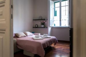 Un pat sau paturi într-o cameră la Marbel - Casa vacanze