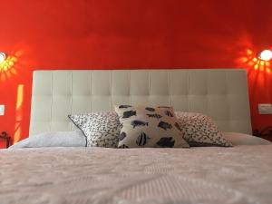 a bedroom with a large bed with red walls at Albamare in Monterosso al Mare