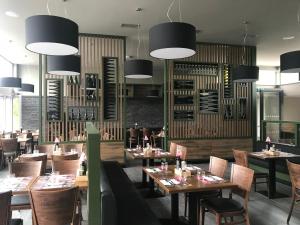 a restaurant with wooden tables and chairs and lights at Exclusive Pension Vista Mlada Boleslav in Bradlec