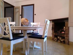 a dining room with a table and chairs and a fireplace at Apartamento 1 Cal Genís - WIFI in Montmajor