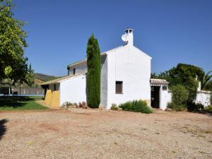 an old white church with a tree in front of it at Belvilla by OYO Cortijo El Morron in Fuentes de Cesna