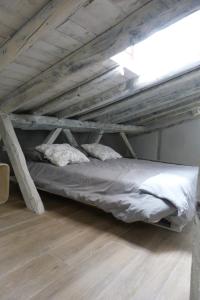 a loft bed with two pillows in a room at Casa de Tintas in Cuenca