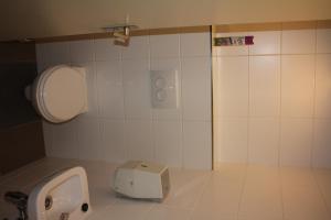 a bathroom with a urinal and a box on the floor at Hotel 't Meertje in Vinkeveen