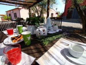 a table with plates of food and drinks on it at Farmhouse Montalto near Sandy Beaches in Montalto di Castro