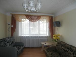 a living room with a couch and a window at Central Daugavpils Apartment in Daugavpils