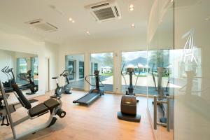 a gym with several treadmills and elliptical machines at Seven Park Hotel Lake Como - Adults Only in Colico