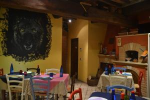 a restaurant with tables and a picture of a wolf on the wall at Il Borgo Del Lupo in Sarteano