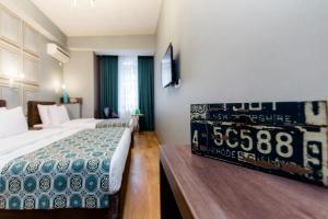 a hotel room with a bed and a table in it at Hotel Diamond in Tbilisi City