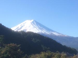 a snow covered mountain on top of a hill at Hotel Route-Inn Kawaguchiko in Fujikawaguchiko