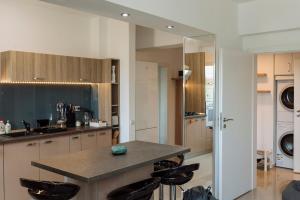a kitchen with a island with black stools at Luxury Flat 9 near Metro in Bucharest