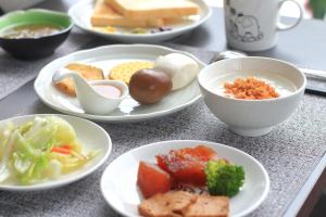 a table with plates of food and bowls of food at Eastern love B&B in Ruisui