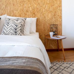 a bedroom with a bed and a side table at Azuleixo in Aveiro
