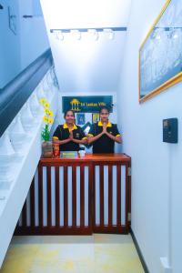 two men are standing behind a bar in a staircase at SRI LANKAN VILLA in Galle