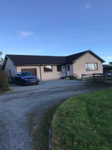 a car parked in front of a house at Stroma in Portree