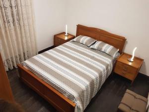 a bedroom with a bed and two night stands with two lamps at Paradise View in Gaula