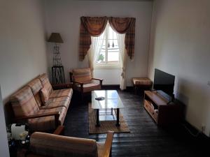 a living room with a couch and a tv at Paradise View in Gaula