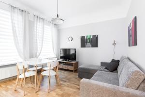 a living room with a couch and a table at Kuninga City Center Apartment in Pärnu