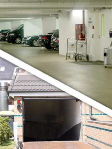 a garage with cars parked in a parking lot at Strandhotel Sylt Westerland in Westerland