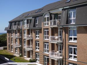 un edificio de apartamentos con balcones en un lateral en Strandhotel Sylt GmbH, en Westerland