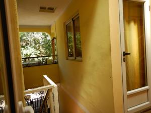 a yellow room with a door and a balcony at Sweet Beach Bungalow in Tamarin