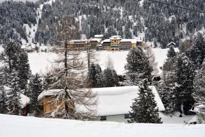 a ski lodge in the snow in a mountain at Apartment Ski in - Ski out in Turracher Hohe