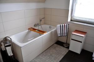 a white bath tub in a bathroom with a window at Appartement -Ferienwohnung in Stadtallendorf