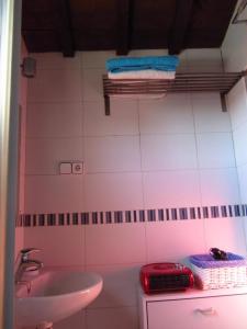 a pink bathroom with a sink and a toilet and a sink at La Plata in Toledo