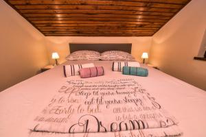 a bedroom with a bed with writing on it at Vacation house Nina in Sukošan
