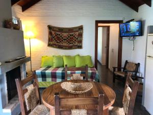 a living room with a couch and a table at Complejo Pueblo del Sol in Piriápolis