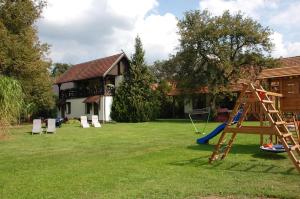 un patio con columpios y parque infantil en Pension Lukask en Burg (Spreewald)