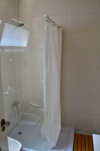 a bathroom with a shower with a toilet and a sink at Holiday House 4 You in Funchal