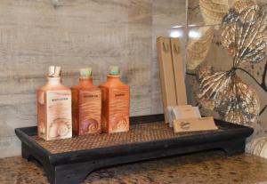 three bottles sitting on a tray on a table at Nilaveli Beach Resort - Level 1 Certified in Nilaveli