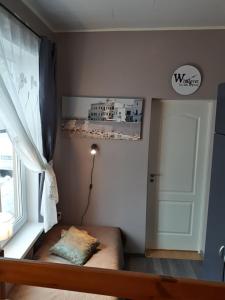 a room with a window and a door with a pillow at Chelsea Karusselli 3 Apartment in Pärnu