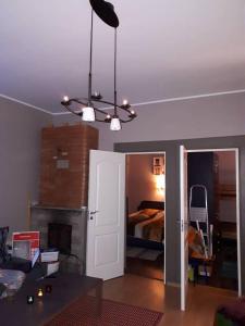 a room with a bedroom with a bed and a chandelier at Chelsea Karusselli 3 Apartment in Pärnu