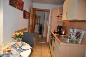 a small kitchen with a table and a sink at Ferienwohnung Möderndorfer, Fulpmes in Fulpmes