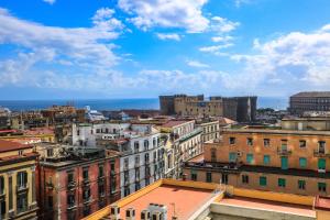 a view of a city with buildings and the ocean at Il Grattacielo b&b in Naples