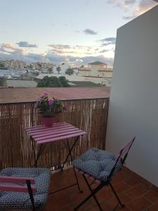 a table and two chairs on a balcony with a table at Sol y Luz in Isla del Moral